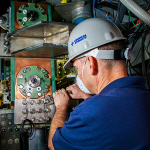 An engineer uses a wrench