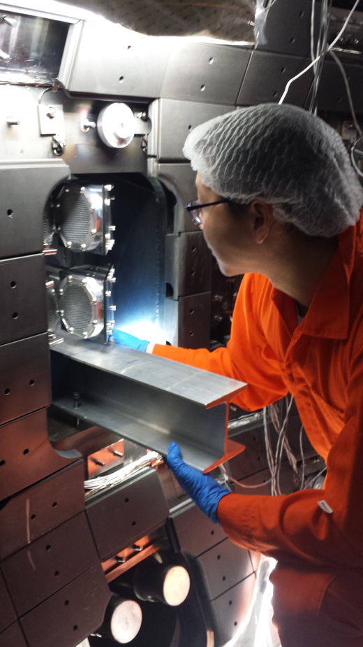 A scientist works on a diagnostic in the reactor vessel.